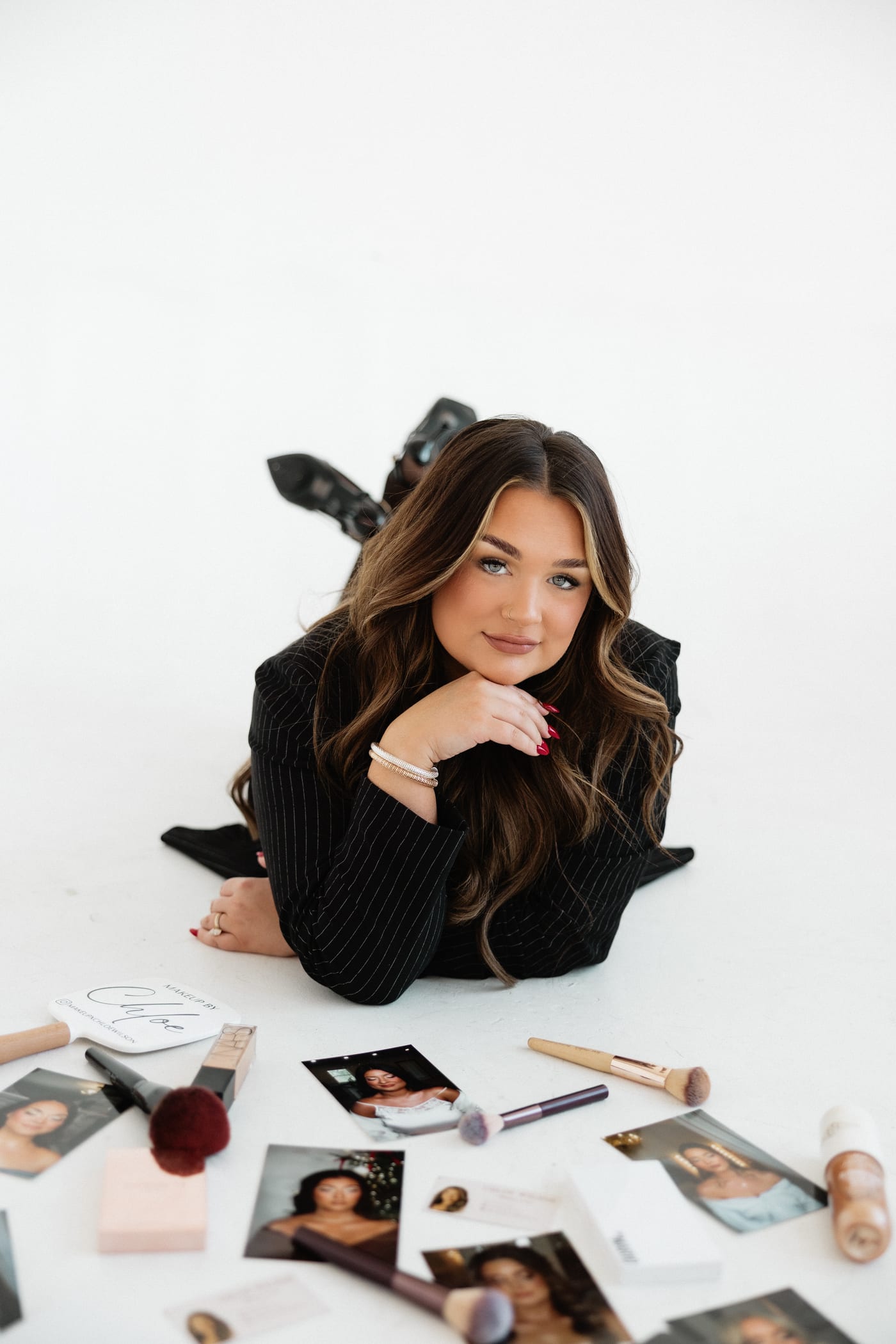 Chloe with her professional makeup kit laid out around her